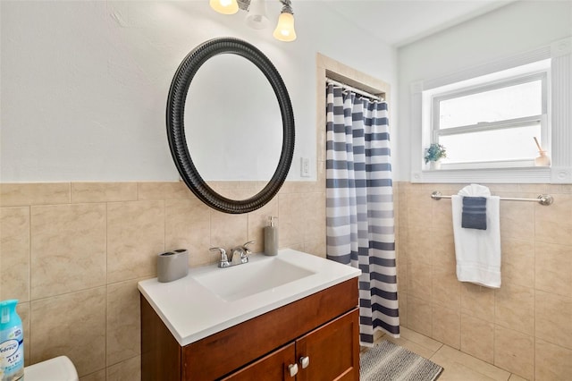 bathroom featuring tile walls, vanity, and tile patterned floors