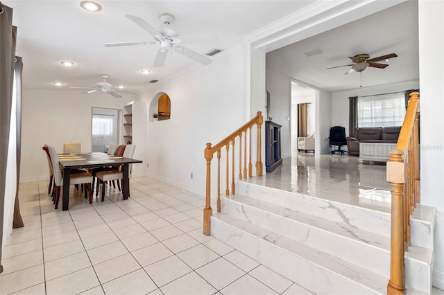 dining room featuring ornamental molding, light tile patterned floors, and ceiling fan