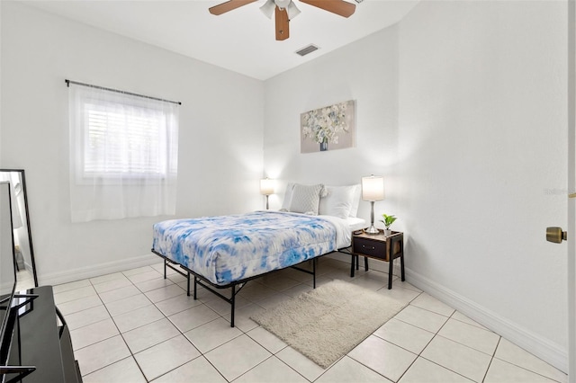 tiled bedroom with ceiling fan