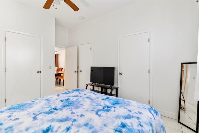 tiled bedroom with ceiling fan