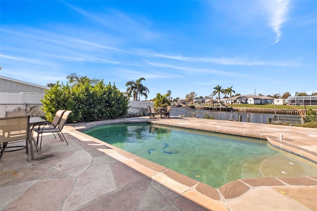 view of pool featuring a patio and a water view