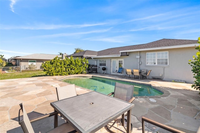 view of pool with a grill and a patio