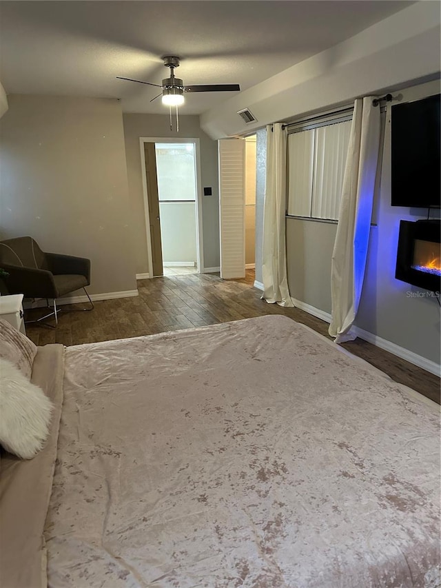 bedroom with ceiling fan and wood-type flooring