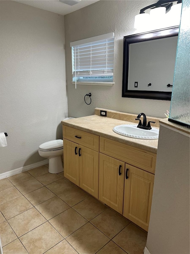 bathroom with tile patterned flooring, vanity, and toilet