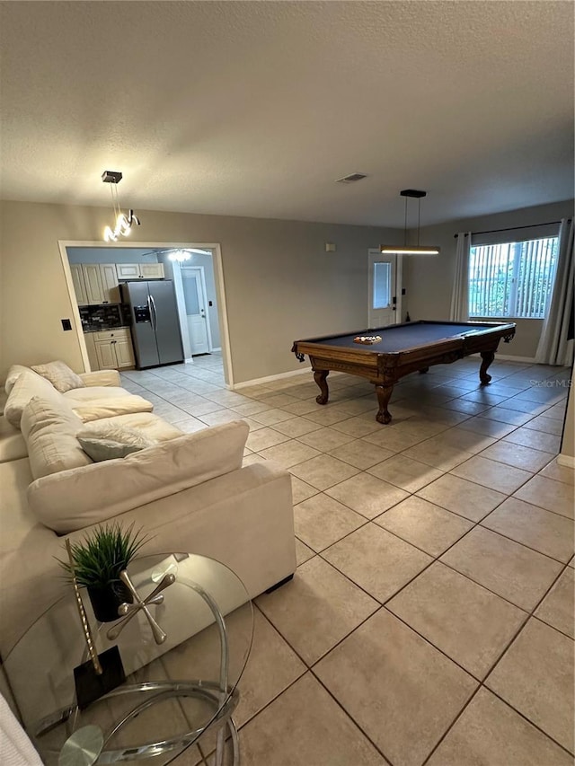 playroom with light tile patterned flooring, a textured ceiling, and billiards