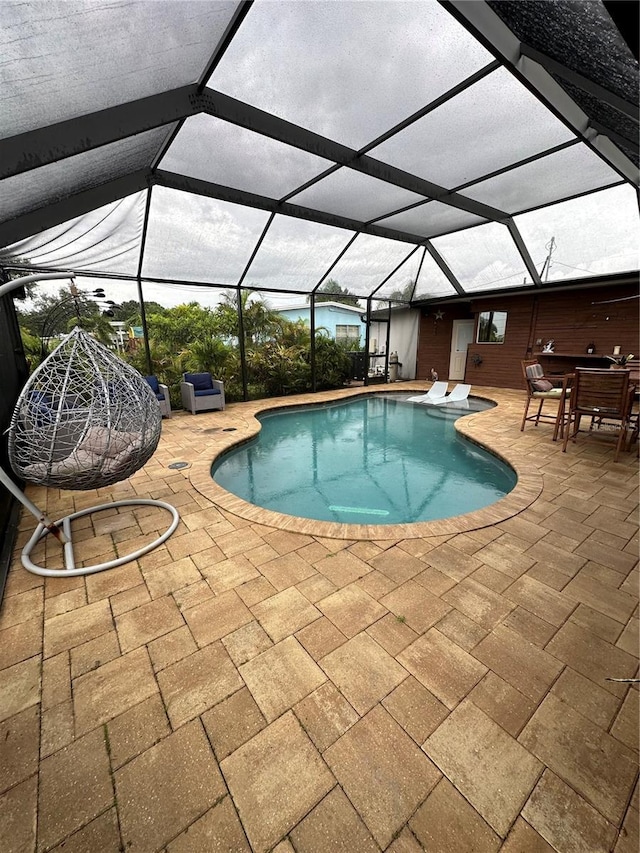 view of pool featuring a lanai and a patio