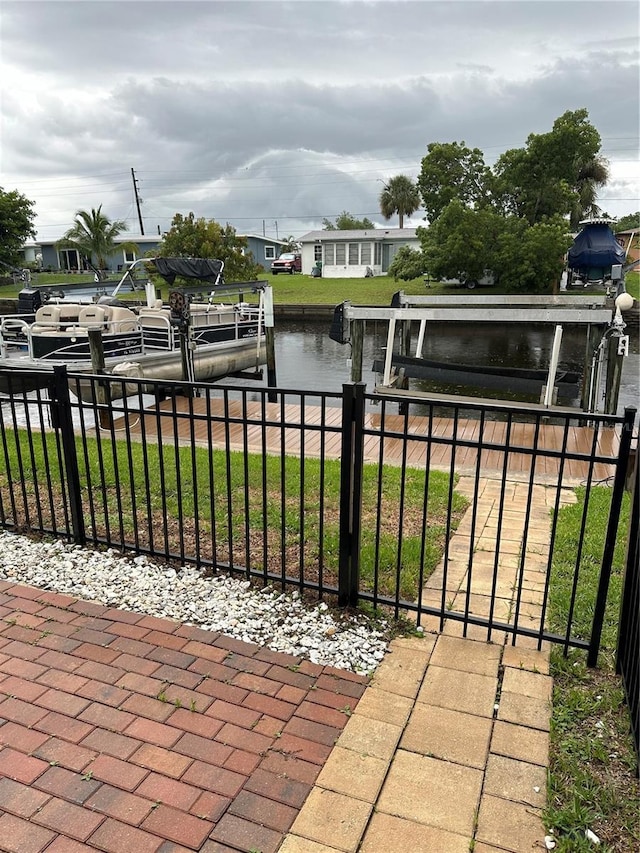 exterior space featuring a water view and a dock