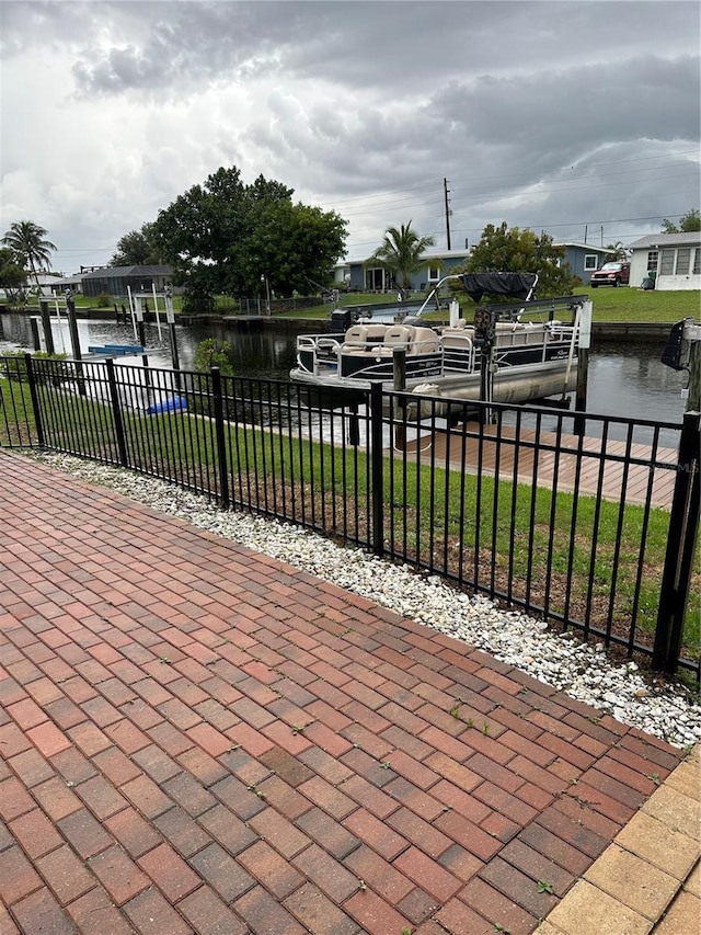 view of patio / terrace with a water view and a dock