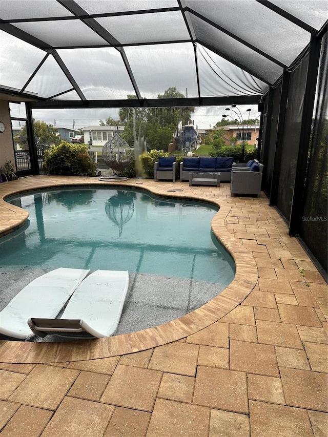 view of swimming pool with a lanai, an outdoor hangout area, and a patio area