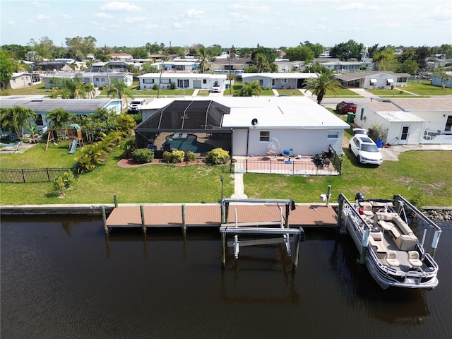 view of dock featuring a water view, a lanai, and a lawn