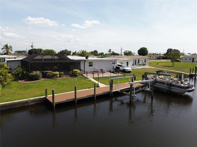 dock area with a water view, a yard, and a lanai