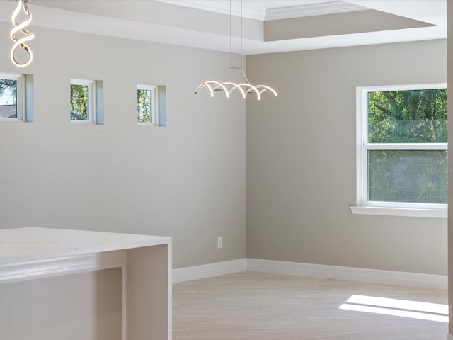 unfurnished dining area featuring ornamental molding and light hardwood / wood-style floors