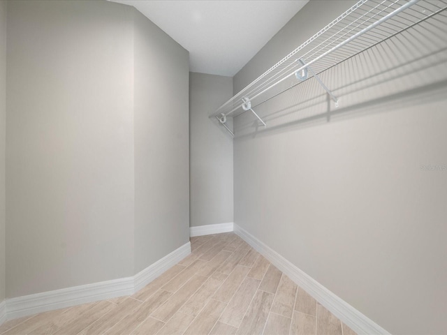 spacious closet featuring light hardwood / wood-style floors