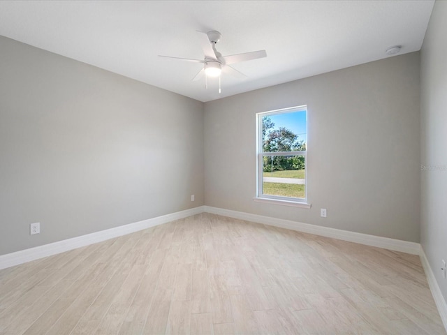 empty room with ceiling fan and light hardwood / wood-style floors