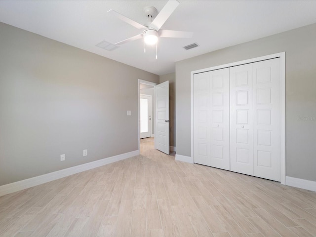 unfurnished bedroom featuring ceiling fan, light hardwood / wood-style floors, and a closet