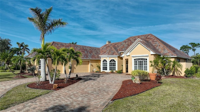 view of front facade with a garage and a front yard