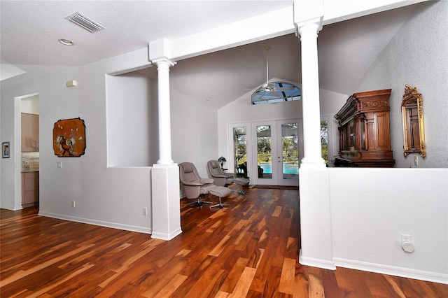 interior space featuring ornate columns, lofted ceiling, dark hardwood / wood-style flooring, and french doors