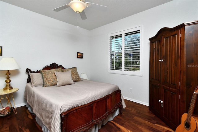 bedroom featuring ceiling fan and dark hardwood / wood-style floors