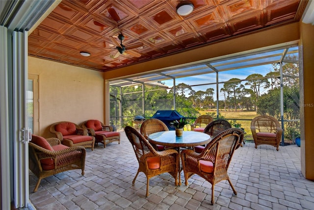 sunroom featuring ceiling fan