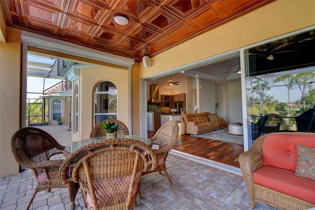 sunroom / solarium featuring ceiling fan