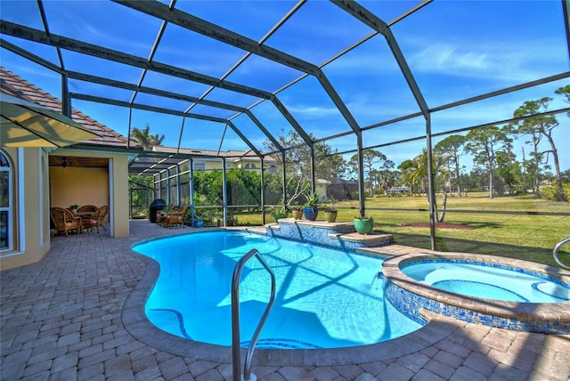 view of pool featuring an in ground hot tub, a lanai, a lawn, and a patio