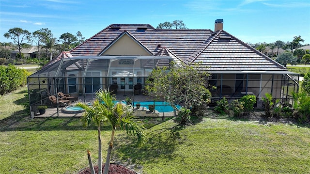 back of house with a lanai, a patio area, and a lawn