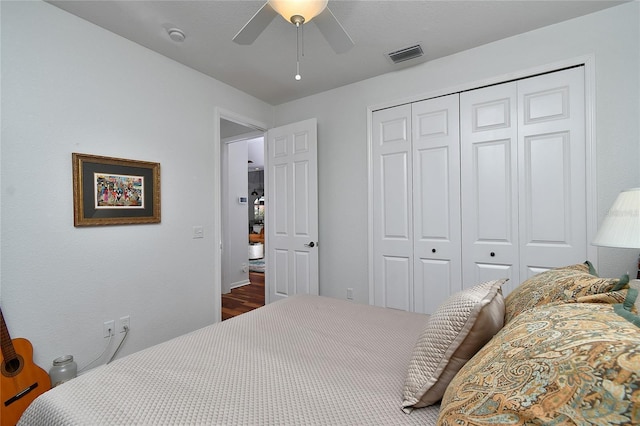 bedroom with ceiling fan and a closet