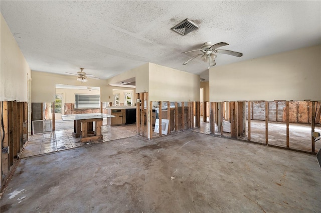 interior space featuring concrete flooring, ceiling fan, and a textured ceiling