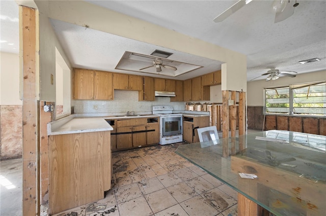 kitchen featuring ceiling fan, a tray ceiling, a textured ceiling, and electric range