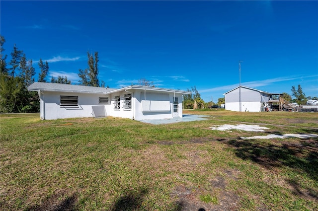 rear view of property with a yard