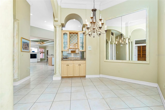 interior space featuring a chandelier, light tile patterned floors, and ornamental molding