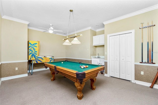 recreation room featuring pool table, crown molding, ceiling fan, a wainscoted wall, and light carpet