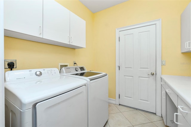 washroom featuring light tile patterned flooring, cabinet space, and independent washer and dryer