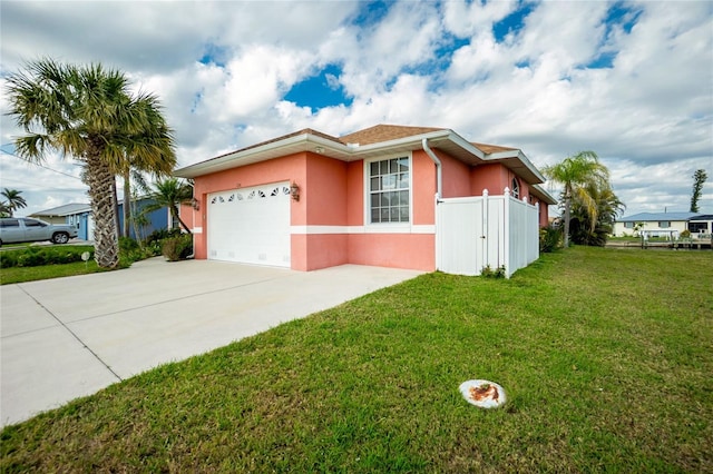 single story home featuring a front lawn, fence, stucco siding, a garage, and driveway