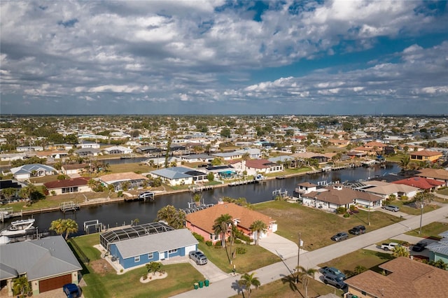 bird's eye view with a residential view and a water view