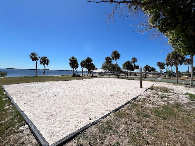 view of home's community featuring a water view and volleyball court