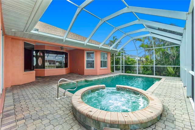 view of pool with a lanai, a ceiling fan, and a patio area