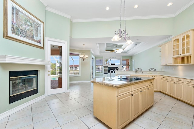 kitchen with light brown cabinets, an inviting chandelier, and ornamental molding