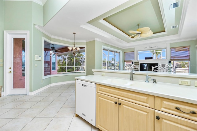 kitchen featuring visible vents, light brown cabinetry, ceiling fan with notable chandelier, a sink, and dishwasher