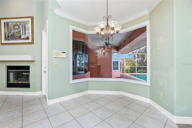 unfurnished dining area with tile patterned floors, baseboards, a chandelier, and ornamental molding