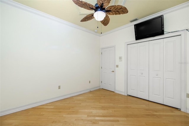 unfurnished bedroom featuring visible vents, crown molding, ceiling fan, baseboards, and light wood-type flooring