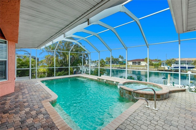 view of swimming pool featuring a lanai, a patio area, a pool with connected hot tub, and a water view