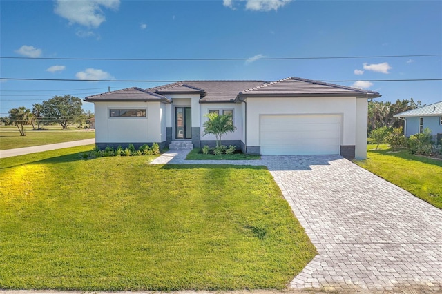 view of front of home featuring a garage and a front lawn