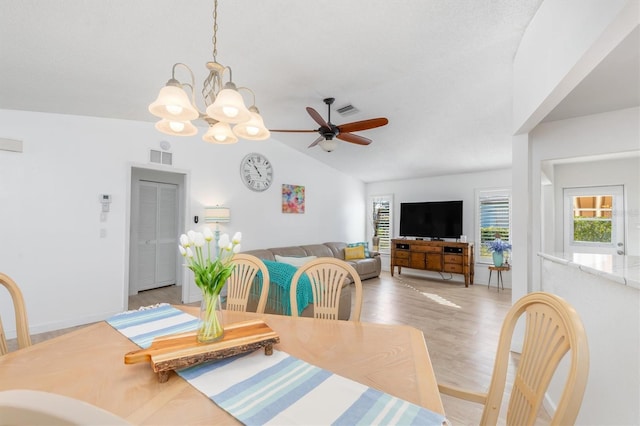 dining area featuring vaulted ceiling, ceiling fan, and light hardwood / wood-style floors