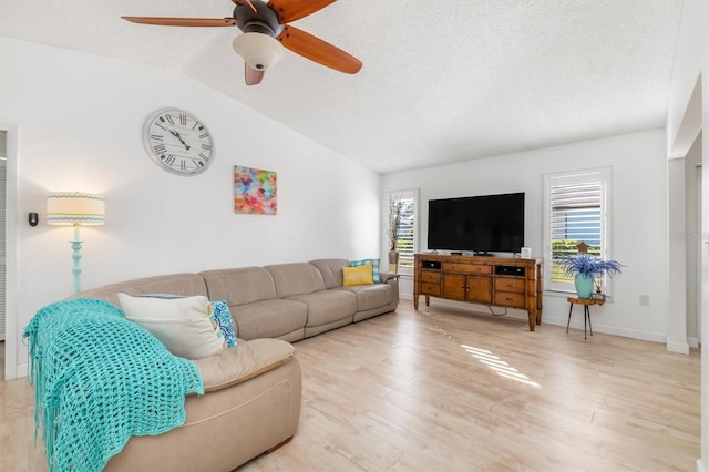 living room featuring hardwood / wood-style flooring, ceiling fan, vaulted ceiling, and a textured ceiling