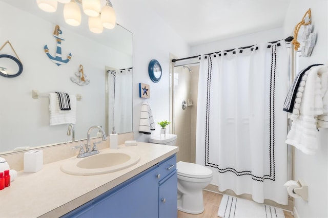 bathroom with vanity, walk in shower, and toilet