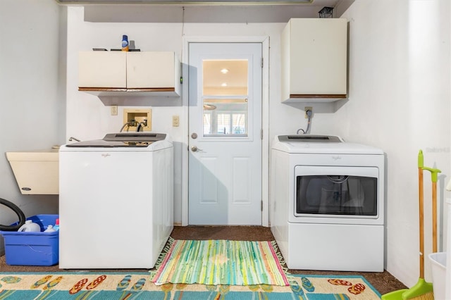 laundry room featuring sink, washer and clothes dryer, and cabinets