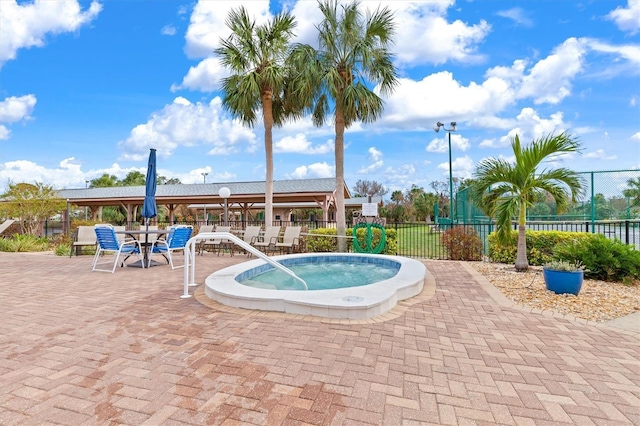 view of pool featuring a community hot tub and a patio area