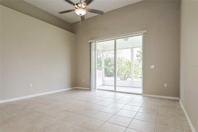 tiled spare room with ceiling fan