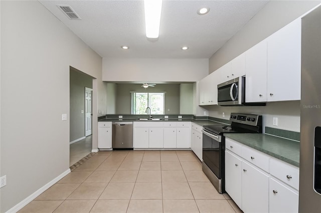 kitchen with appliances with stainless steel finishes, sink, and white cabinets